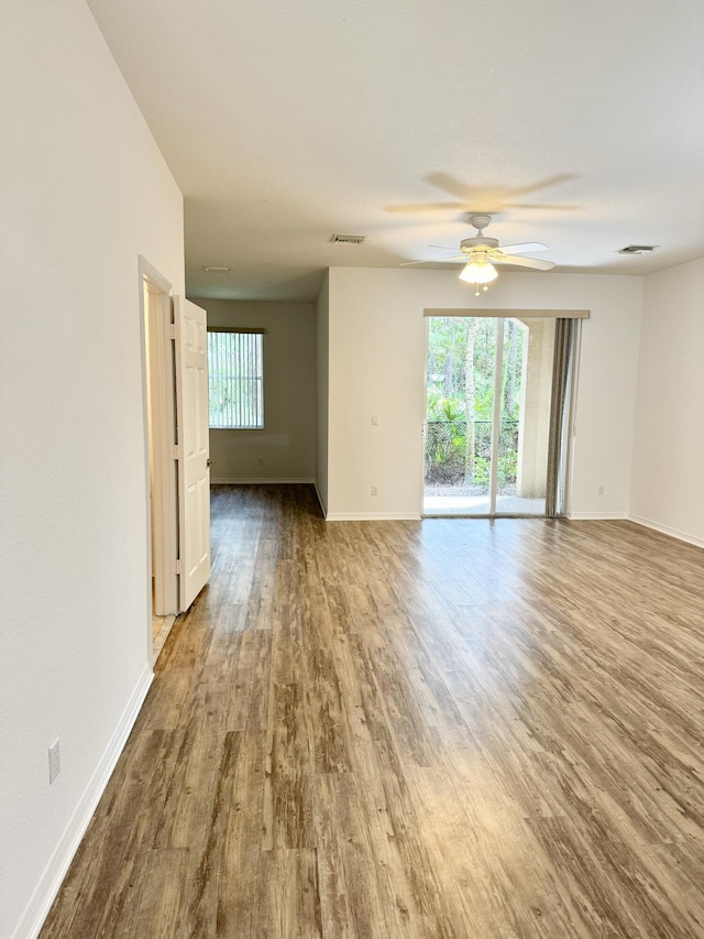 empty room with ceiling fan and hardwood / wood-style floors