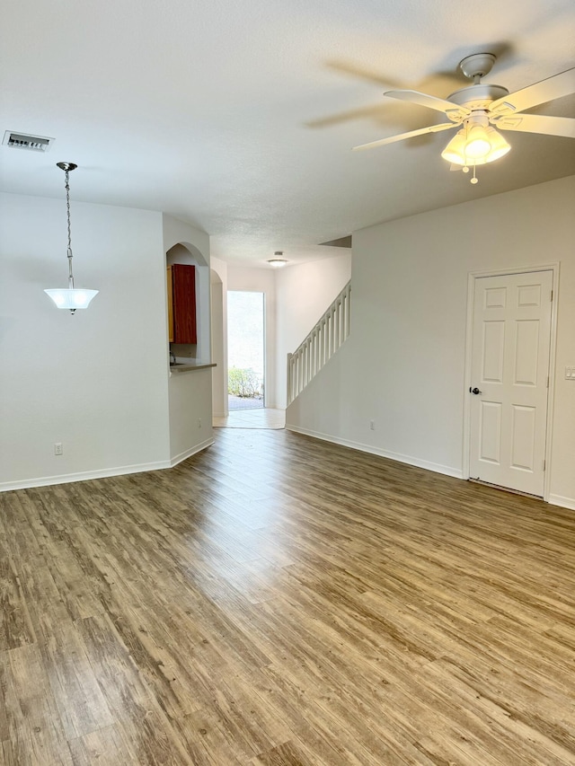 empty room featuring ceiling fan and hardwood / wood-style floors