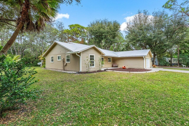 ranch-style home featuring a garage and a front yard