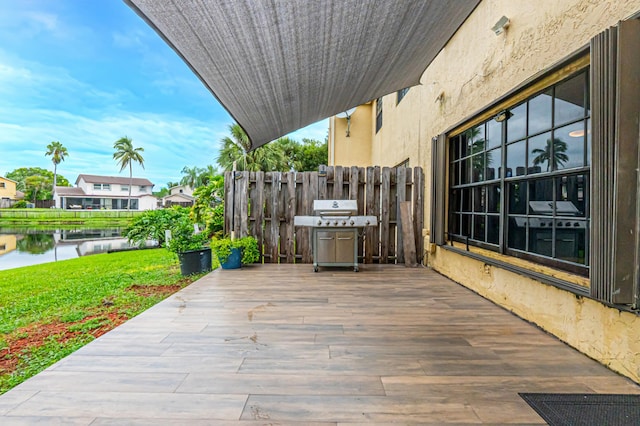 view of patio featuring a grill and a water view