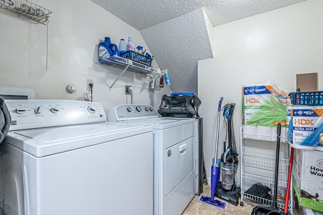 laundry room featuring a textured ceiling and washer and clothes dryer