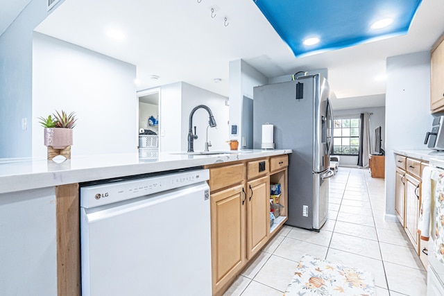 kitchen with stainless steel refrigerator with ice dispenser, light brown cabinets, sink, light tile patterned flooring, and white dishwasher