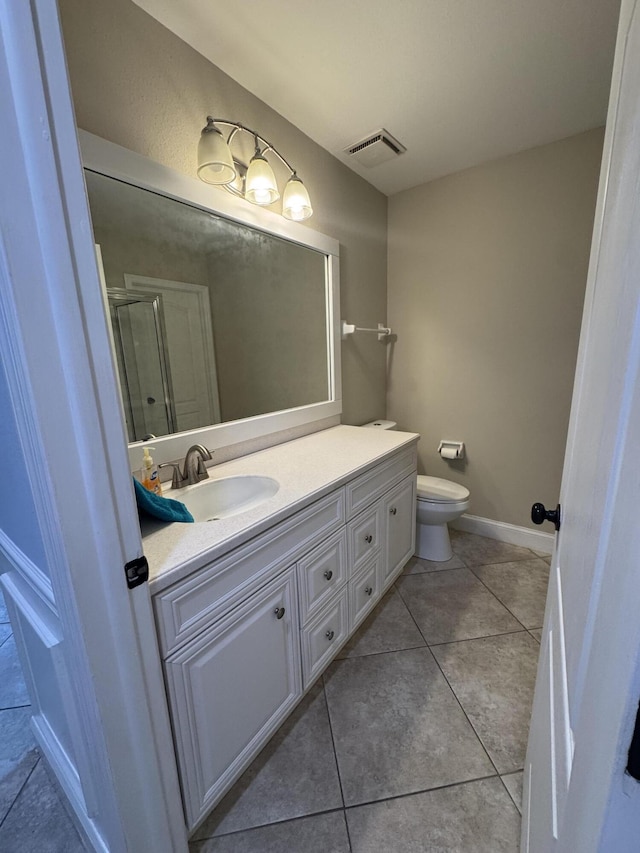 bathroom featuring visible vents, baseboards, toilet, tile patterned flooring, and vanity