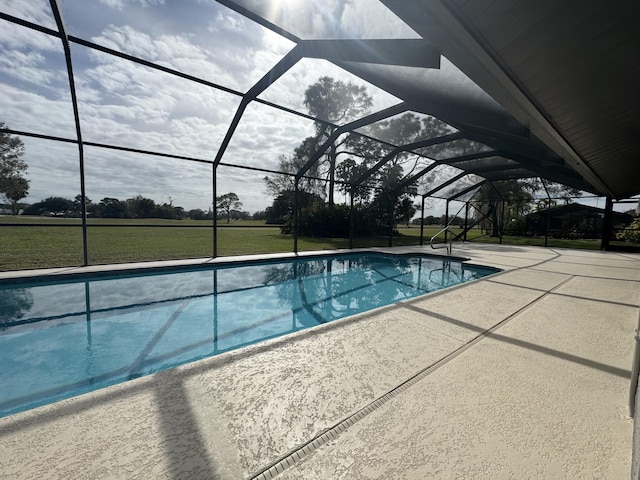 view of swimming pool with a patio, a yard, and glass enclosure