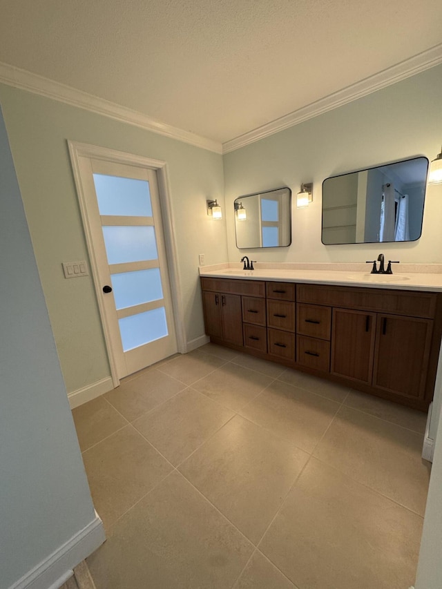 bathroom with tile patterned flooring, vanity, and crown molding