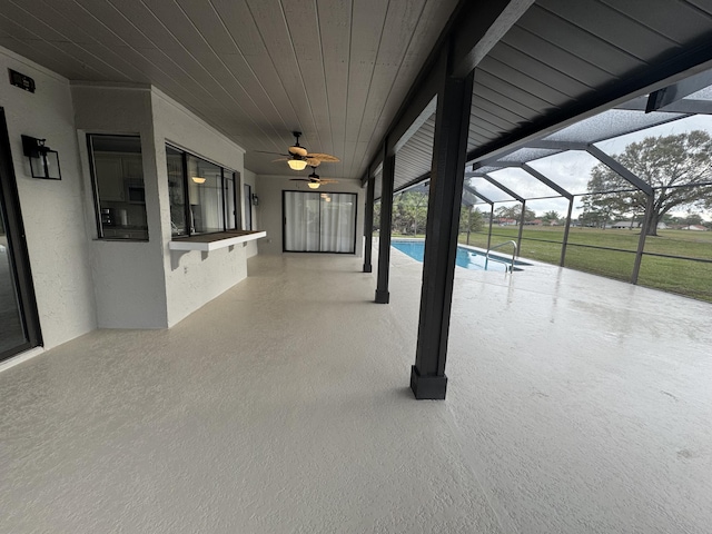 view of swimming pool with ceiling fan, a lanai, and a patio area