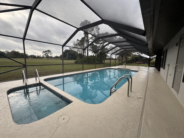 pool featuring a lanai, a patio area, and a yard