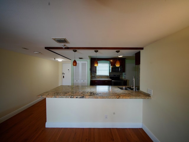 kitchen with a peninsula, range with electric stovetop, a sink, light stone countertops, and decorative light fixtures