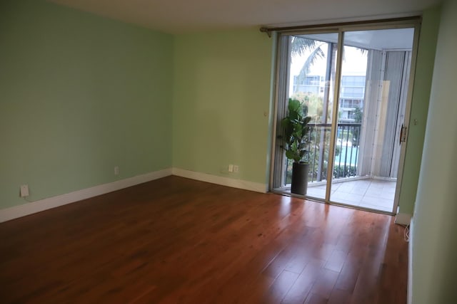 empty room featuring baseboards and wood finished floors