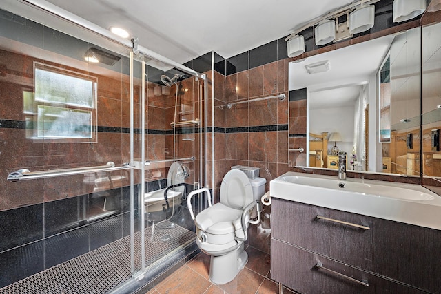 bathroom featuring toilet, vanity, tile walls, walk in shower, and tile patterned floors