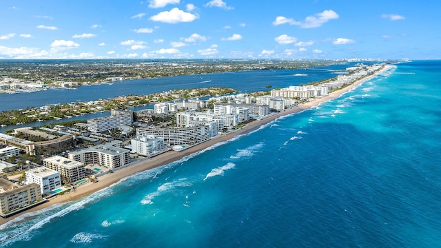 bird's eye view featuring a water view and a beach view