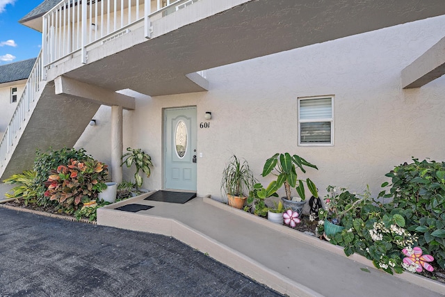 view of exterior entry featuring a balcony