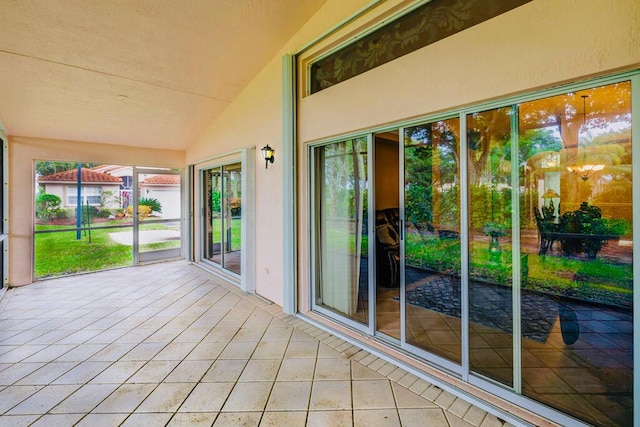 unfurnished sunroom with vaulted ceiling