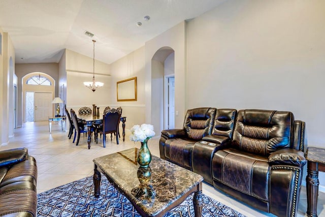 living area featuring visible vents, arched walkways, a chandelier, high vaulted ceiling, and light tile patterned flooring