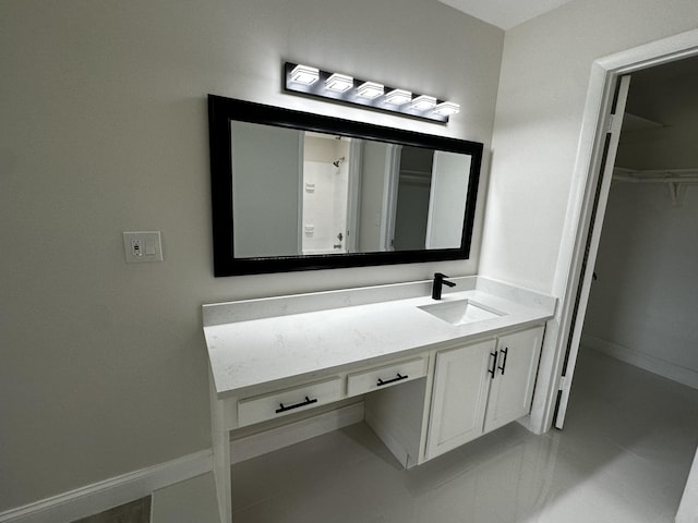 bathroom with vanity and a shower