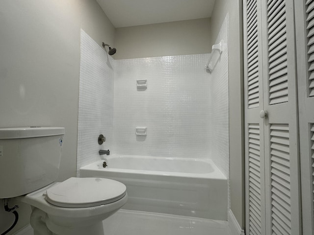 bathroom with toilet and tiled shower / bath combo