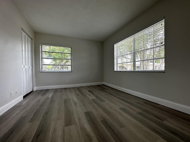 spare room with dark hardwood / wood-style floors