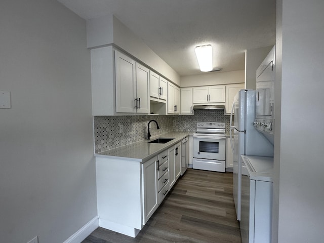 kitchen with stacked washer and clothes dryer, white electric range oven, tasteful backsplash, white cabinets, and sink