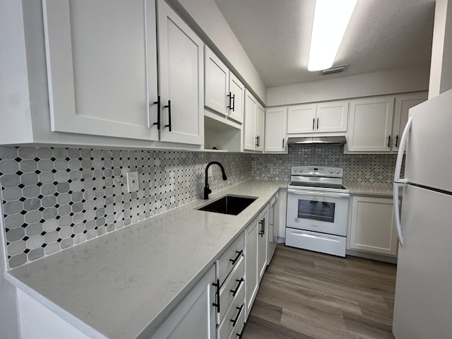 kitchen with white cabinetry, tasteful backsplash, white appliances, a textured ceiling, and sink