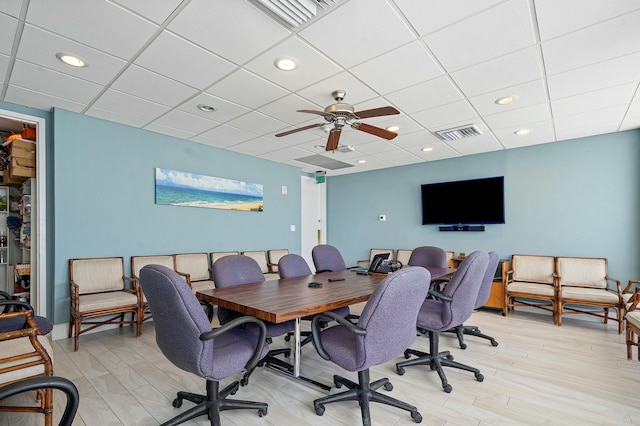 home office with ceiling fan, a paneled ceiling, and light hardwood / wood-style flooring