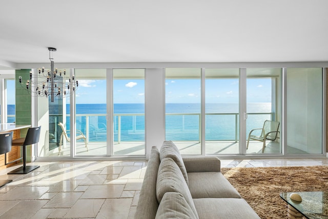 living room featuring a water view and a notable chandelier