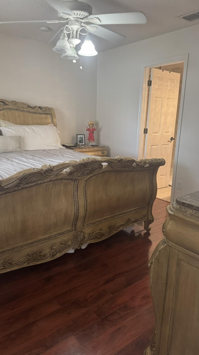 bedroom featuring ceiling fan, connected bathroom, and hardwood / wood-style floors