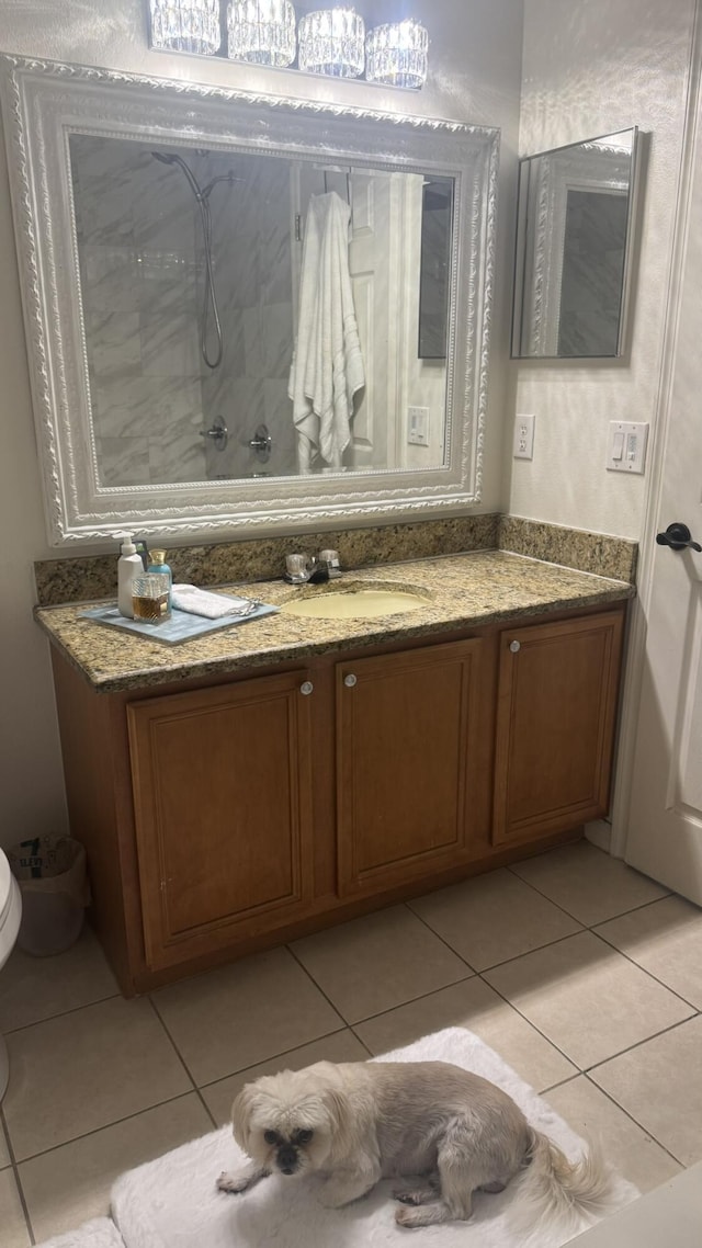 bathroom with tile patterned flooring, vanity, and toilet