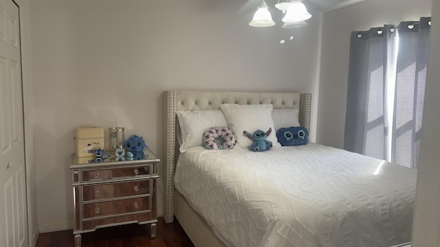 bedroom with dark hardwood / wood-style floors