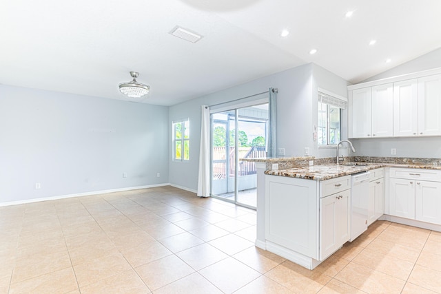 kitchen with a healthy amount of sunlight, light stone counters, white cabinets, and white dishwasher