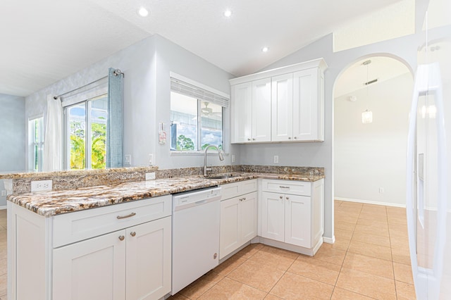 kitchen with sink, white dishwasher, a wealth of natural light, light stone countertops, and white cabinets