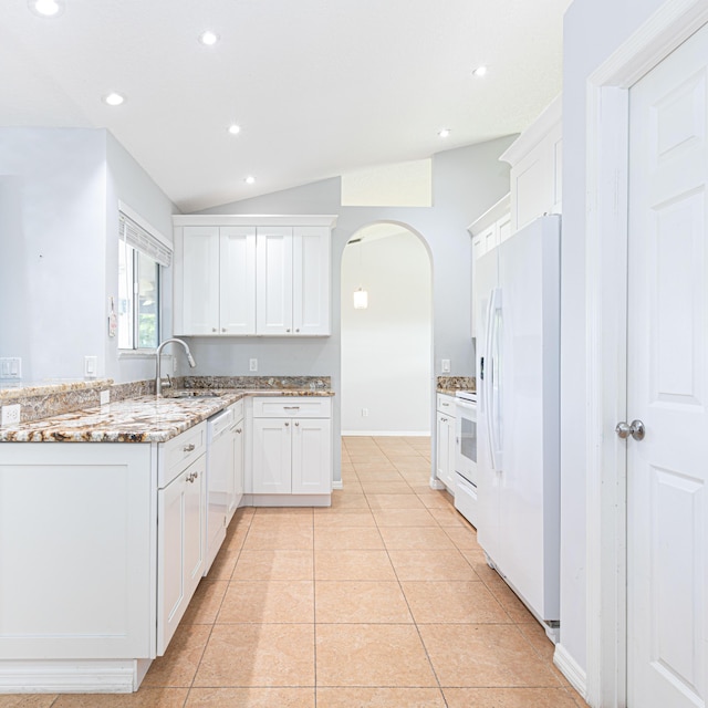 kitchen featuring sink, white appliances, white cabinetry, light stone counters, and light tile patterned flooring