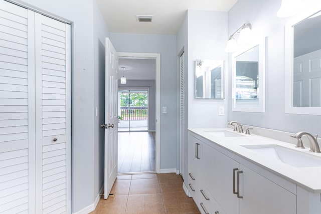 bathroom featuring tile patterned flooring and vanity