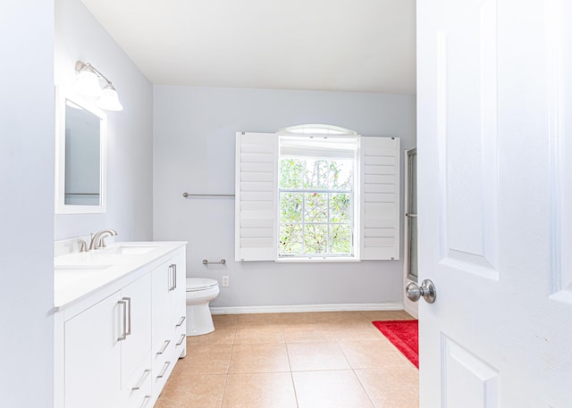 bathroom with vanity, toilet, and tile patterned flooring