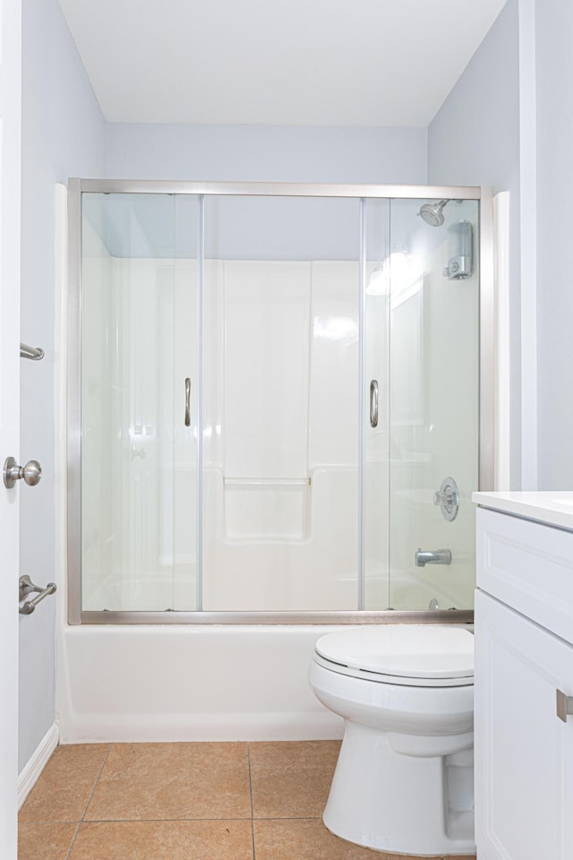 full bathroom with tile patterned flooring, vanity, shower / bath combination with glass door, and toilet