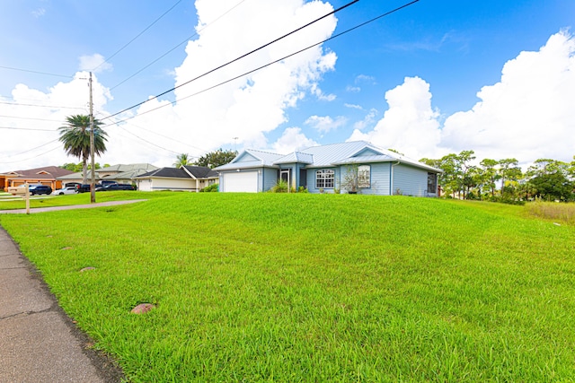 single story home with a garage and a front yard