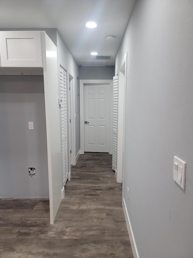 corridor with dark hardwood / wood-style floors