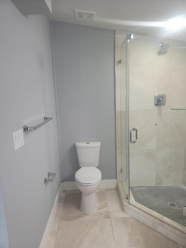 bathroom with toilet and a shower with shower door