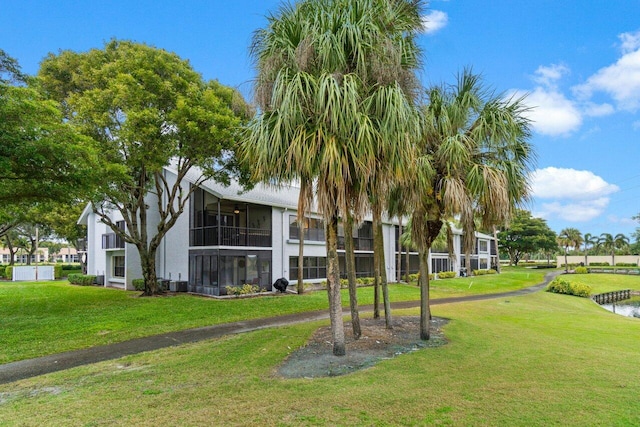 view of property's community with a lawn