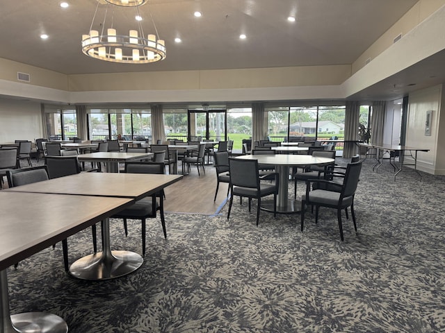 dining area with plenty of natural light and an inviting chandelier