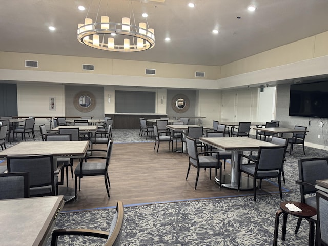 dining space featuring an inviting chandelier and dark hardwood / wood-style floors