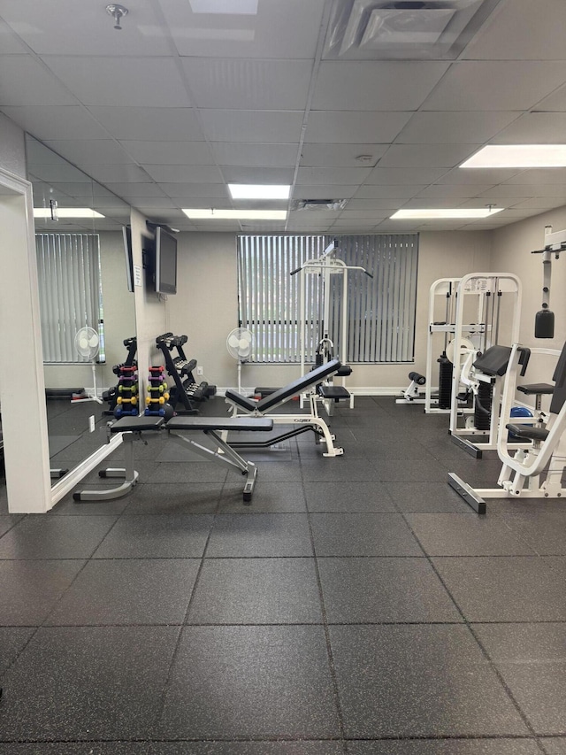 gym with a paneled ceiling