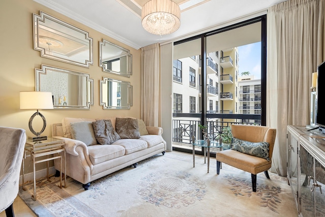 living area featuring expansive windows, a notable chandelier, and ornamental molding