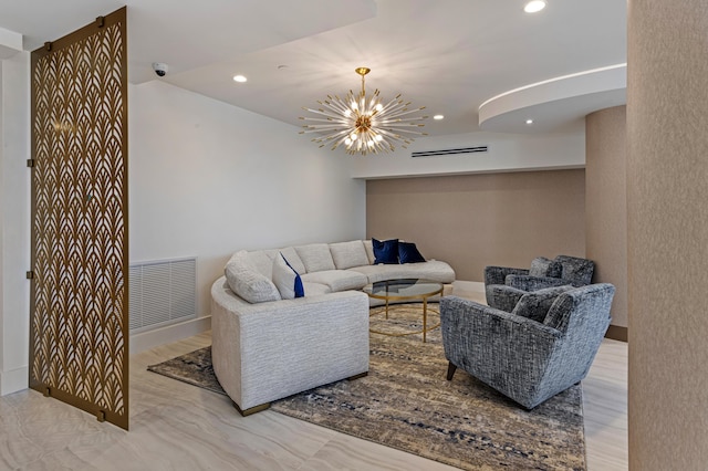 living room with a wall unit AC and a notable chandelier