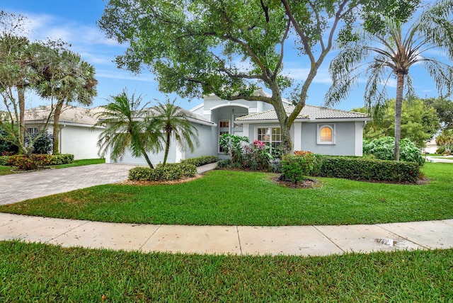 ranch-style home with a front yard and a garage