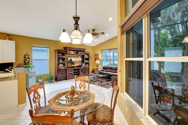 tiled dining area featuring lofted ceiling and an inviting chandelier