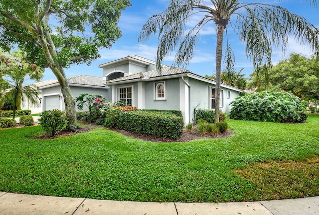 view of front facade with a garage and a front yard