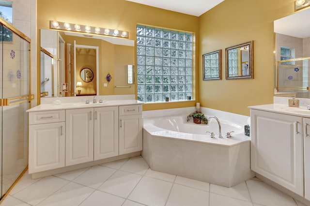 bathroom featuring vanity, tile patterned floors, and plus walk in shower