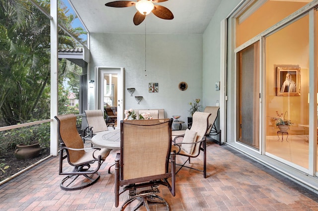 sunroom / solarium featuring ceiling fan