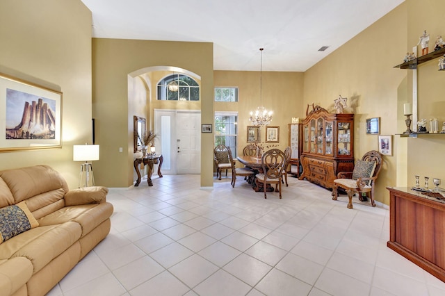 tiled living room featuring a notable chandelier