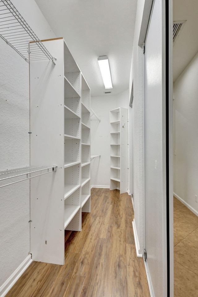 spacious closet with wood-type flooring